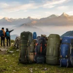 Collection of top-rated hiking rucksacks resting along a mountain trail with scenic alpine valley views.