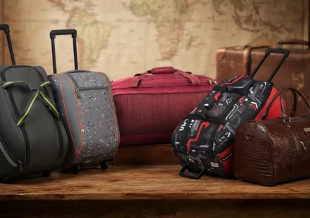 ​Best duffel bags for travel and luggage showcasing various rolling and leather designs on a wooden table with a world map background